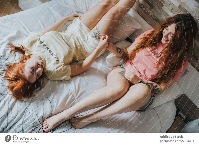 Women With Tattoos Resting On Bed bed woman bedroom indoors leisure pillow alternative art bedding comfort couple cozy crop faceless female friend friendship
