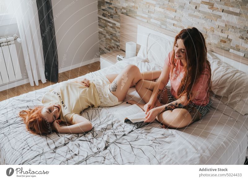 Women With Tattoos Resting On Bed bed bedroom indoors woman pillow leisure alternative art bedding comfort couple cozy female friend friendship fun gay