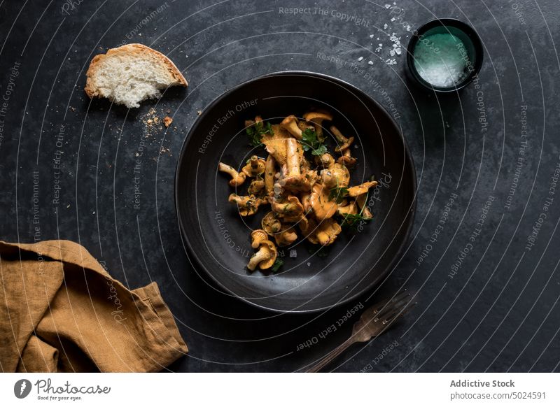Bowl of chanterelle mushrooms on table bowl bread salt black layout cuisine natural composition full raw uncooked food yellow edible season meal gourmet organic