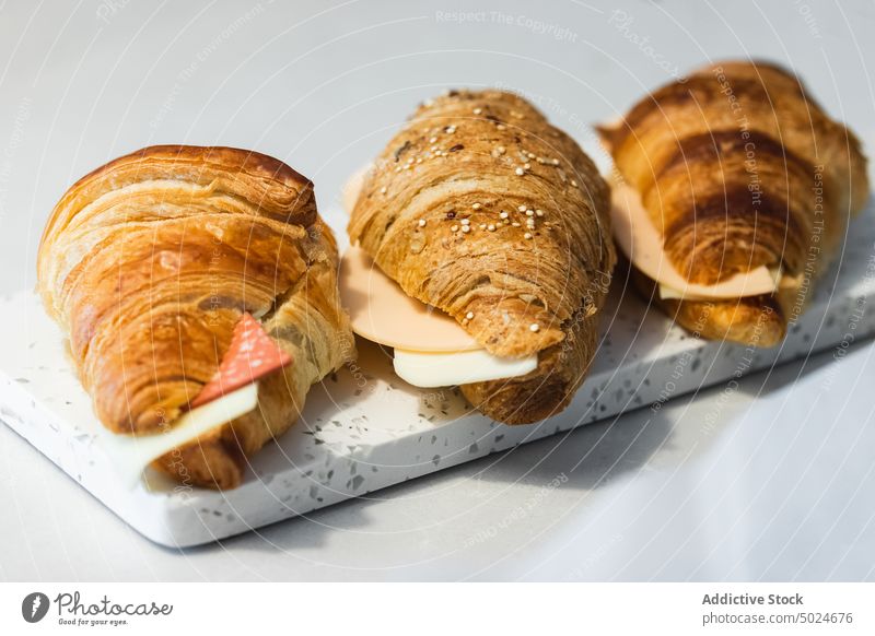 Tasty croissants with cheese and ham meat bun tasty fresh tray table food vegan cuisine serve meal gastronomy palatable appetizing delicious gourmet delectable