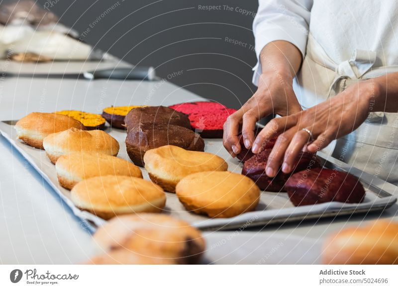 Crop cook putting sponge cakes on tray in kitchen baker dessert prepare vegan bakery sweet cuisine delicious chef tasty pastry gastronomy confectionery food
