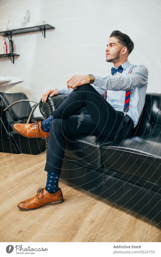 Portrait of a barber in a barbershop barber shop beard beauty care client clipper cut elegant hair haircut hairdresser hands head indoor lifestyle male man