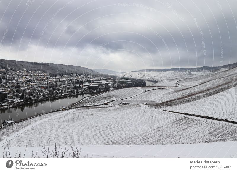 Enchanting aerial scenic view of the Mosel valley and the town of Bernkastel-kues Germany covered in snow during winter mosel valley bernkastel-kues germany