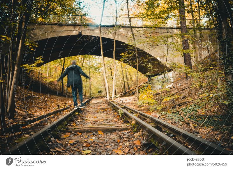 balancing on old rusted tracks Man Old Railroad tracks rails lost places Bridge Decline Broken Transience Change renaturation abandoned Apocalyptic sentiment