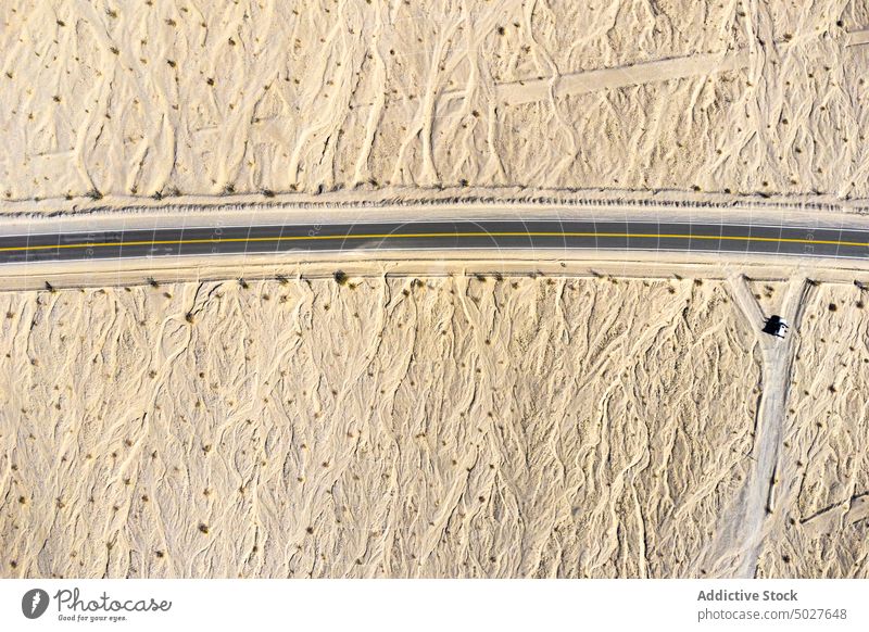 Drone view of asphalt road going through sandy valley in California highway mountain Death Valley landscape roadway National Park scenery route nature highland