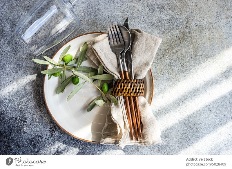 Rustic summer table setting autumnal ceramic cutlery dinner dinnerware eat eating food fork knife leaves meal napkin olive peace place plate rustic silverware