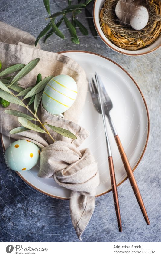 Cutlery set for Easter dinner concrete cutlery easter eggs festive food holiday branch napkin nest olive setting silverware spring table catering elegant decor