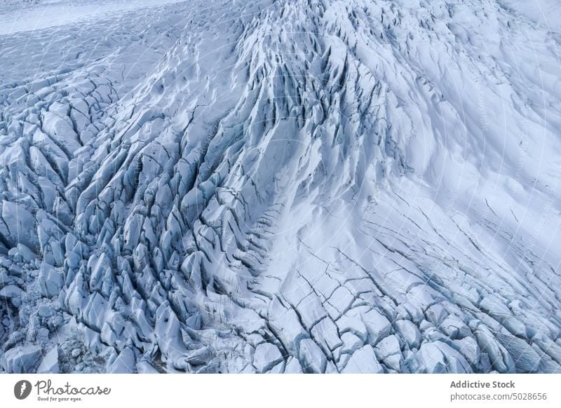 Textured background of massive ice cap glacier volcanic formation slope snow surface texture nature abstract wild rough geology pattern terrain winter crack