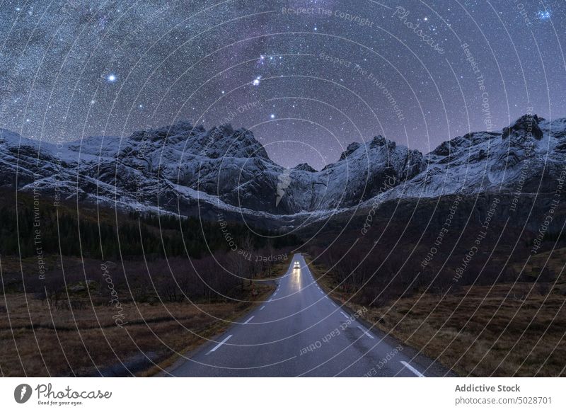 Car on road under starry sky at night car milky way mountain winter scenery norway lofoten islands nature highland automobile drive idyllic empty scenic cold
