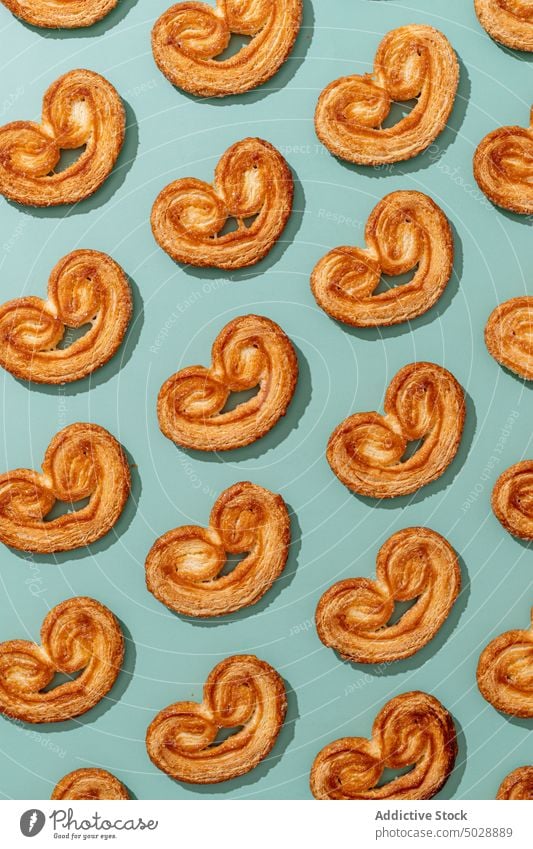 Even rows of sweet palmier cookies elephant ear dessert appetizing tasty baked food pastry delicious french cuisine patisserie bakery culinary palatable yummy