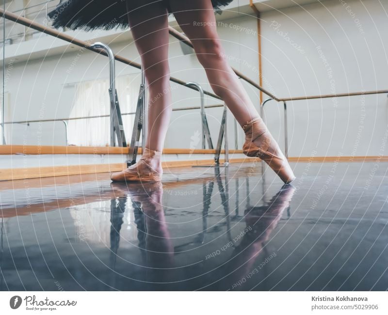 Ballerina in ballet pointe stretches on barre in gym. Woman practicing in dance studio. Work out of young girl. art balance ballerina beam beautiful caucasian