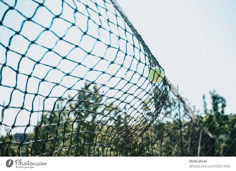 Time stop image of a tennis ball crashing against the court net with copy space, sport concept game competition match play set action athletics bankruptcy