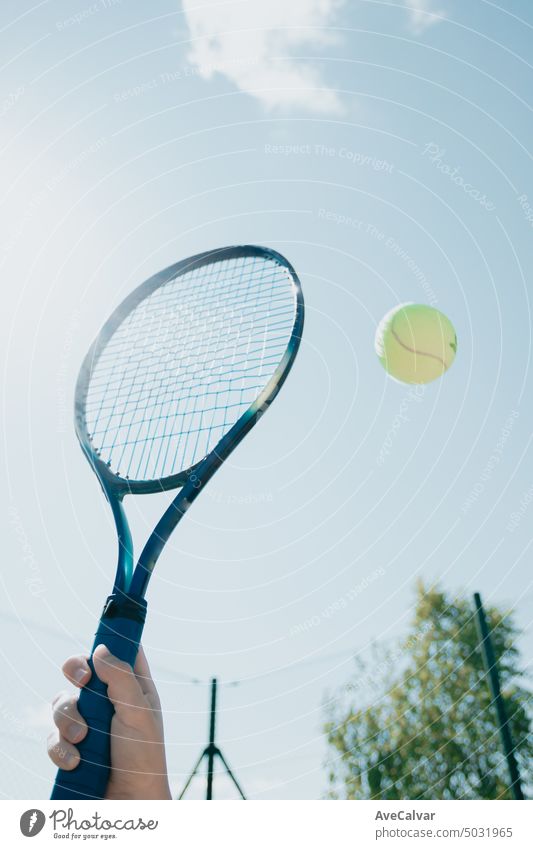 Close up image of a tennis racket and a floating ball with copy space. person woman competition court game play player sport active female athlete athletic
