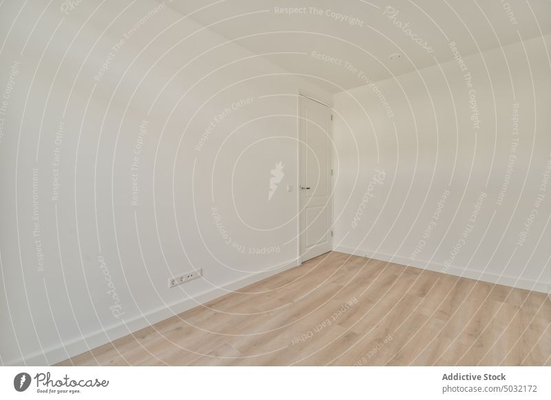 Empty room with white walls apartment empty floor door parquet home simple light spacious minimal flat residential house daylight shape rectangular corner