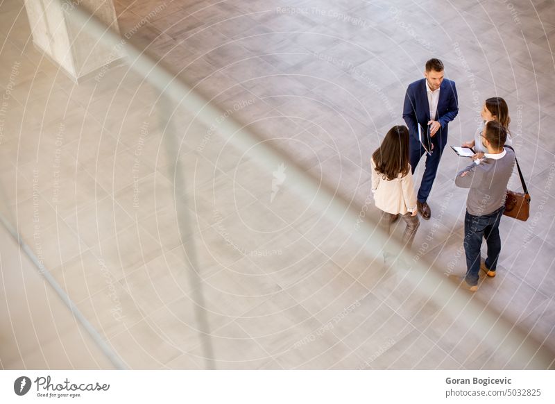 Aerial view at business people team discussing in the office hallway above aerial tablet angle businesspeople caucasian colleague communication contemporary