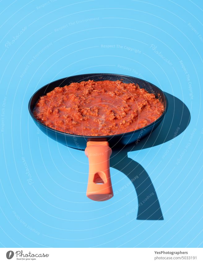 Bolognese sauce in a pan isolated on a blue background above beef bolognese bright carbs classic close-up color cooking copy space creative cuisine cut out