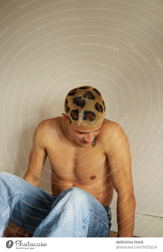 Shirtless young man with dyed hair smile happy shirtless appearance informal subculture portrait home male leopard individuality wall friendly personality