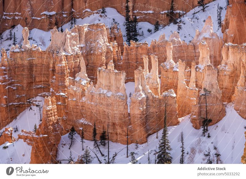 Rocky formations in mountainous terrain snow landscape rocky picturesque hoodoo bryce canyon national park nature winter desert natural tourism geology