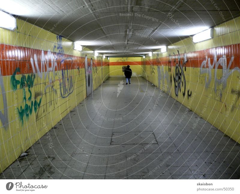 modern underground!? Lamp Human being Train station Bridge Tunnel Pedestrian Graffiti Old Dirty Gloomy Loneliness Premiere Ostbahnhof Painted Wall (building)