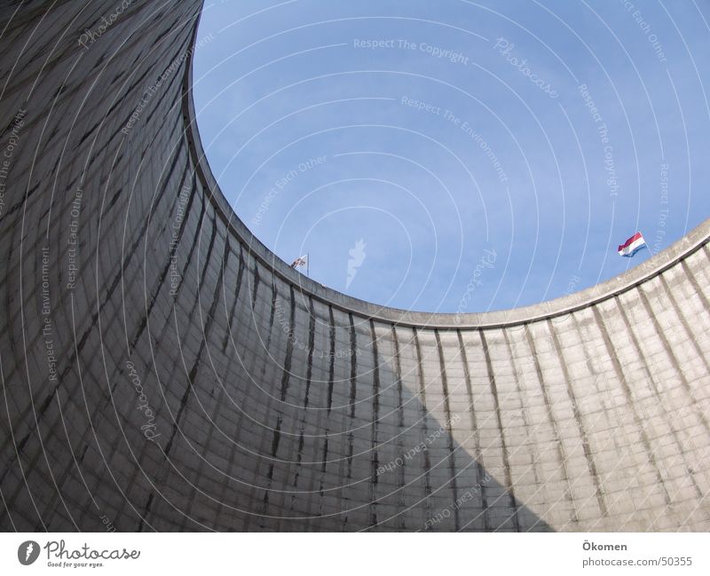 The view Concrete Round Gray Hard Circle Nuclear Power Plant Sky Beautiful weather Blue sky Water top opening huge masses Border in the cooling tower of kalkar