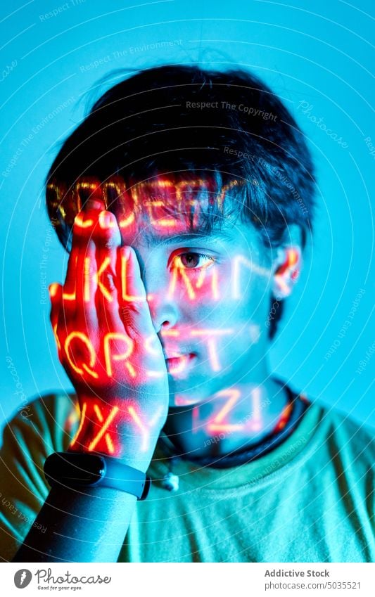 Boy in room with neon light boy portrait kid illuminate cover face vivid bright childhood hide colorful appearance human face blue inside preteen personality