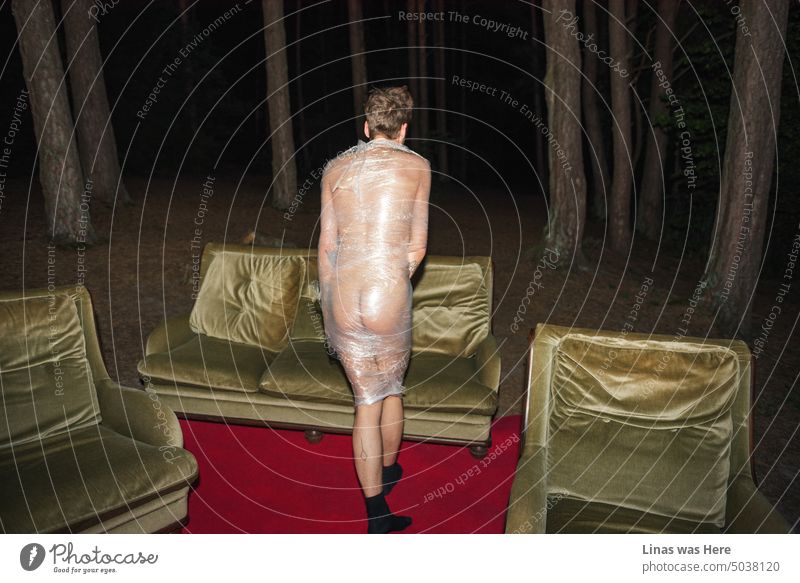 A naked man wrapped up in plastic is wandering in these dark spooky woods. The red carpet and sofa are waiting for him. Halloween and maniac vibes are in the air.