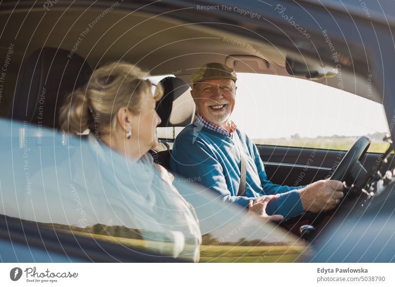 Elderly couple at the wheel of a car voyage Transport Car Street Car journey travel Trip Adventure Driver Public Holiday senior couple Woman two persons Couple