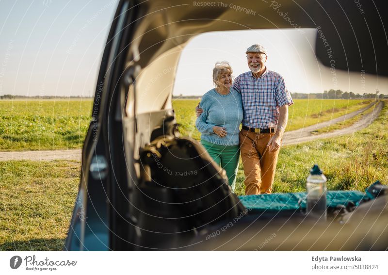 Senior couple on a road trip journey transportation car auto travel adventure holiday senior couple woman two people mature together old retired sunset joy love