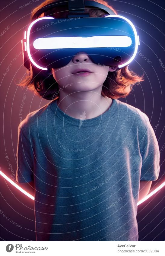 Young kid wearing VR headset, studio portrait, cinematic light person child futuristic goggles reality boy device looking technology 3d amazement cyberspace