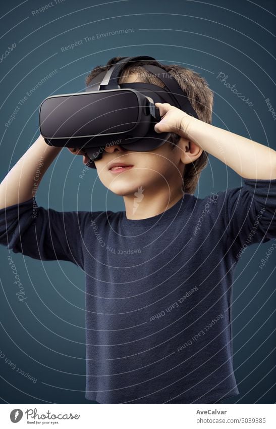 Young kid wearing VR headset, studio portrait, cinematic light person child futuristic goggles reality boy device looking technology 3d amazement cyberspace