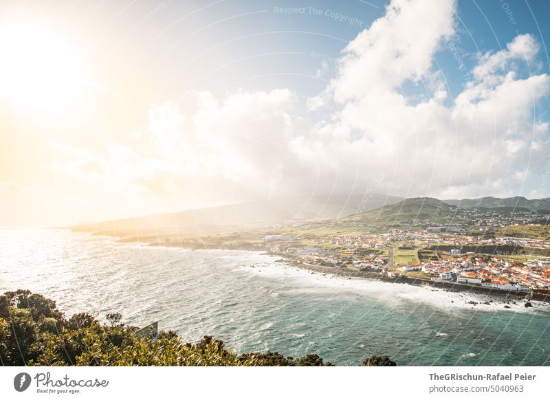 Sun rays, sea and city Azores Vantage point Town Moody Water Waves Clouds Sunlight Beach Hill Volcano Tourism Vacation & Travel Portugal