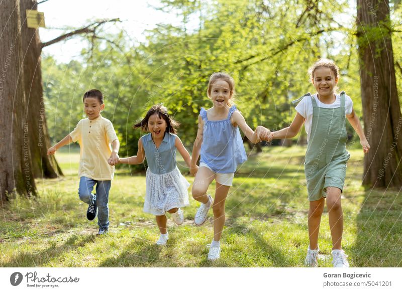 Group of asian and caucasian kids having fun in the park active activity boy bright casual cheerful child childhood children cute descent diverse diversity