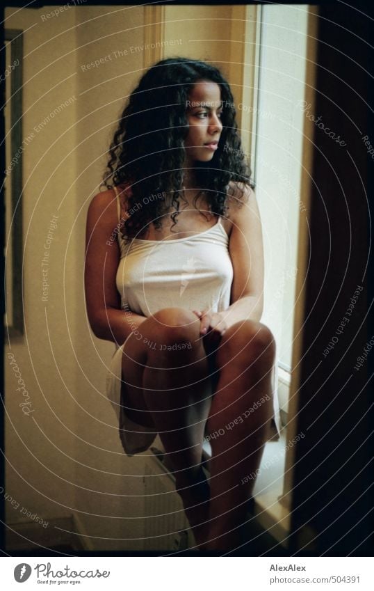 A young beautiful woman sits inside a window frame - analog photography Woman Young woman Long-haired Curly pretty Athletic Slim Legs Barefoot Room inboard