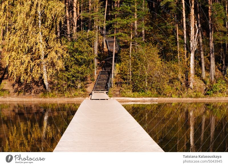Wooden pier and wooden staircase on the lake Baltieji Lakajai in Labanoras Regional Park in autumn, Picturesque nature of Lithuania Autumn Landscape Scenery