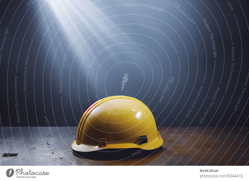Close-up safety matte yellow plastic helmet, indoors modern industry background with copy space. engineer protection security head tool danger hat damage