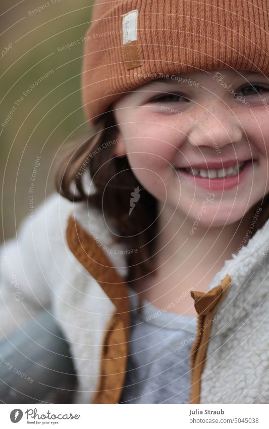 cheeky monkey Girl Freckles Child sheep's wool Jacket Grinning Brash brown hair Cap cheerful child Happiness Schoolchild Autumn Spring play outdoors being out