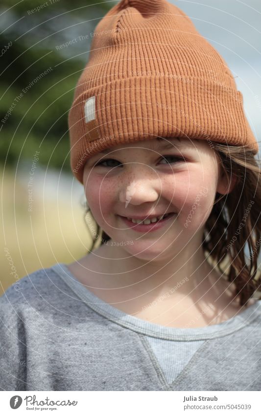 Girl with cap Cap Portrait of a young girl Show your teeth Freckles Grinning hair in the wind Sweater Nonchalance Autumn Spring being out Shadow Human being