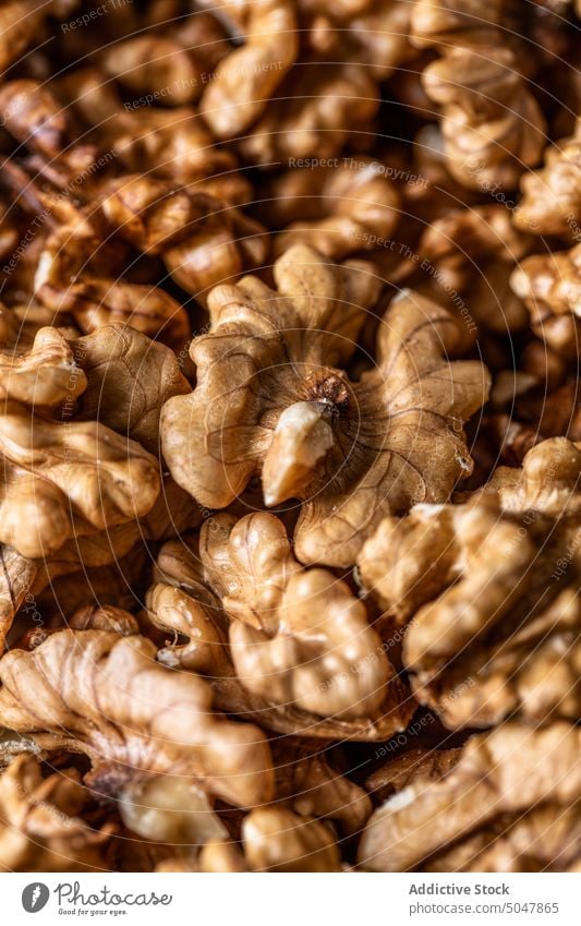 Pile of raw walnuts on table heap fresh brown pile snack food organic background natural whole ingredient crispy delicious healthy culinary gastronomy yummy