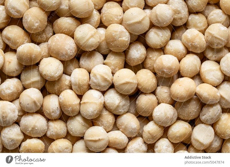 Heap of Macadamia Nuts in sugar powder macadamia nut food scatter tasty background delicious sweet table ingredient nutrition yummy natural fresh organic pile