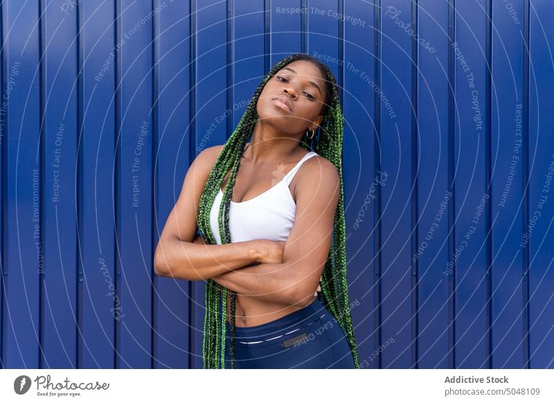 Contemporary young black female with green braids woman individuality self assured portrait cool personality long hair trendy millennial urban confident