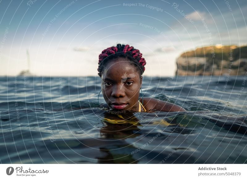 Black woman swimming in sea summer vacation portrait water relax recreation rest female young trip travel tourism tourist daytime sky harmony enjoy calm