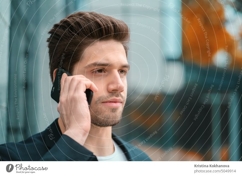 Businessman have serious conversation using cell phone. Business guy in formal suit talks intently with colleague. Office employee, wage worker, weekdays concept