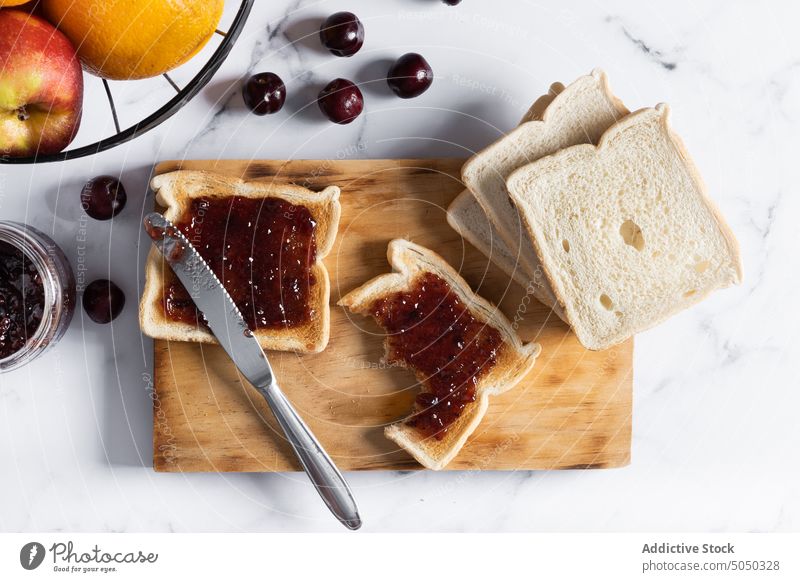 Delicious toasts with jam on cutting board food breakfast delicious berry cherry sweet knife yummy fresh tasty serve appetizing ripe healthy crispy morning