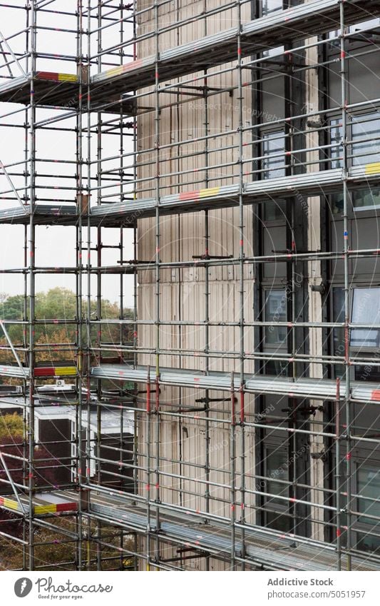 Scaffolding around modern building during renovations frame exterior real estate residential scaffold safety urban structure scaffolding architecture