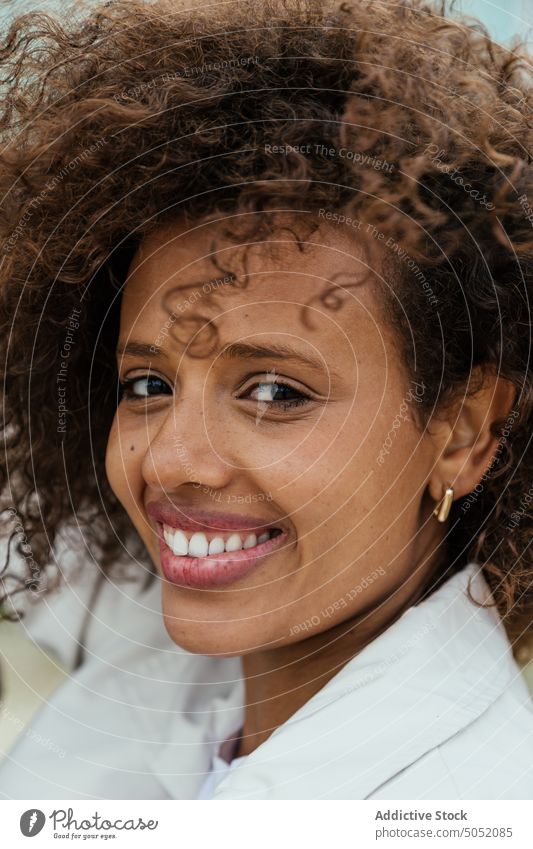 Cheerful black woman looking at camera smile happy sincere style appearance portrait curly hair natural charismatic female ethnic african american young