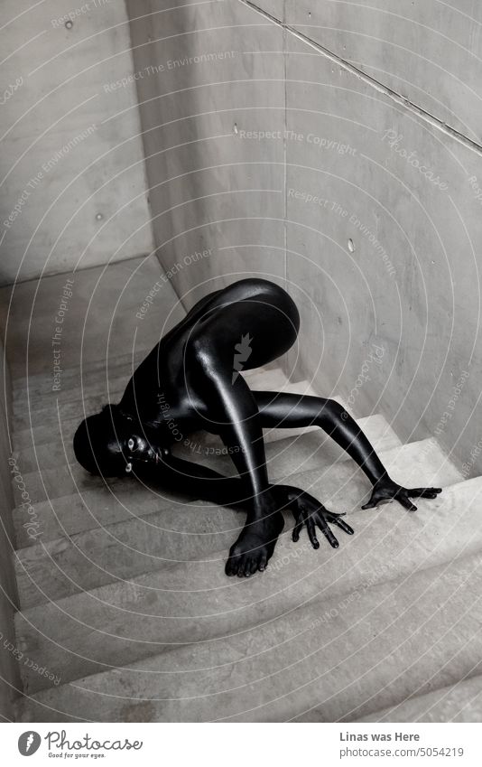 It’s a spooky season and our model painted in black is crawling up these stairs. It’s a horror show. Halloween vibes definitely. Even though this fine art image might be interpreted in various ways.