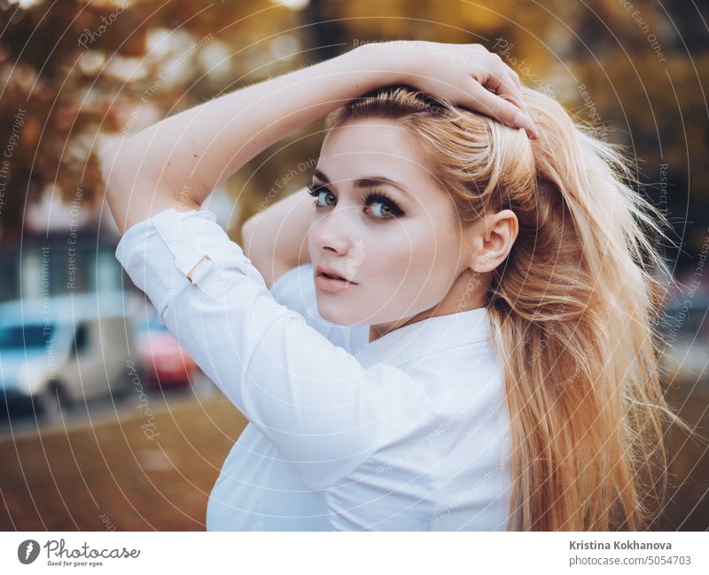 Portrait of young sexy blonde business woman in autumn city. Beautiful lady posing in white blouse in street. adult attractive beautiful beauty body brunette