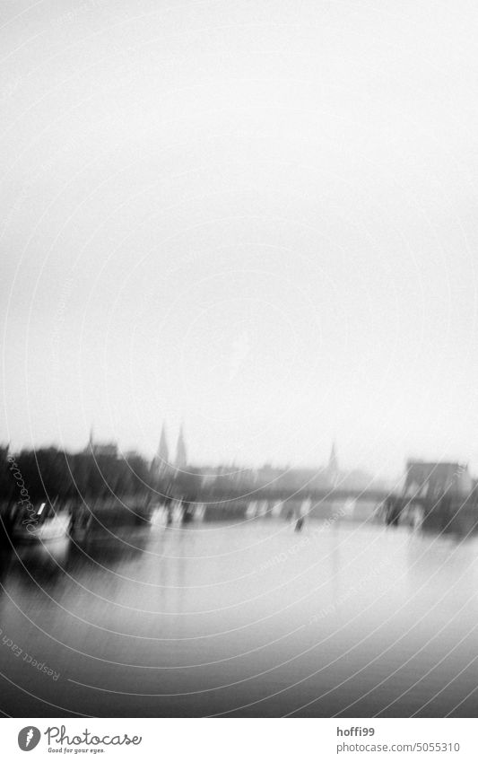 blurred view from Weser river with Bremen in fog Bridge River Fog hazy Abstract blurriness Water Light