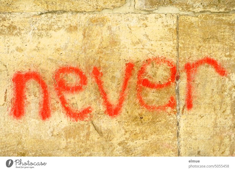 never is written in red letters on a stone wall English Graffiti Scrape damage Daub youth language Red Never spray Cancelation Handwriting Opinion