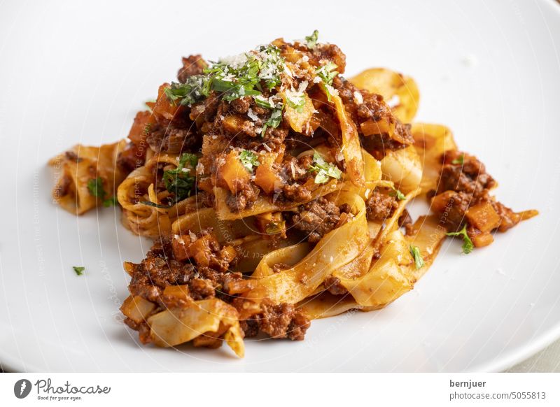 Tagliatelle pasta with bolognaise on a white plate Bolognese Bolognaise Shadow sauce Tomato Minced meat carrot Italian Italy segregated Heap Plate White Eating